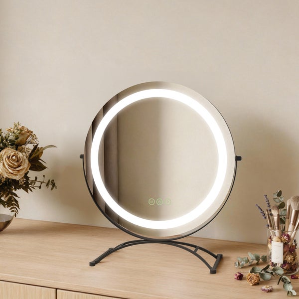 Runder Kosmetikspiegel mit LED Beleuchtung auf einem Tisch