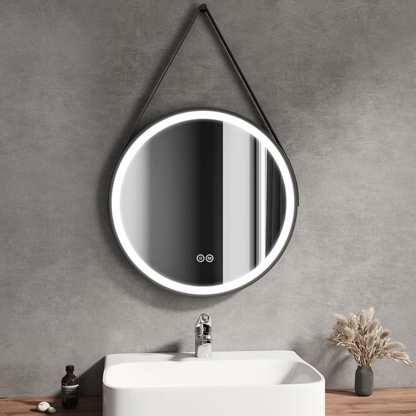 Moderner, runder Badspiegel mit LED-Beleuchtung und schwarzem Rahmen, hängend an einem schwarzen Band über einem weißen Waschbecken, hell und organisiert.