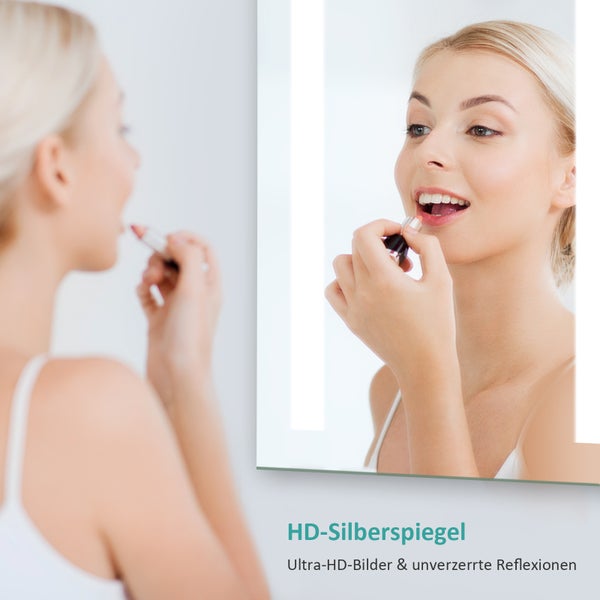 Frau trägt Lippenstift vor einem LED-beleuchteten Spiegel