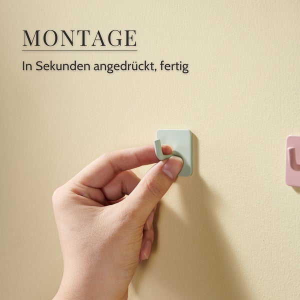 Eine Hand drückt einen selbstklebenden Wandhaken an eine Wand als einfache Montage in Sekunden.