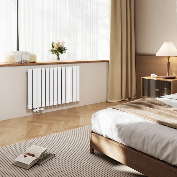 Schlafzimmer mit Heizkörper, Bett und Nachttisch