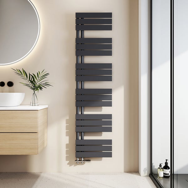 Moderner Design-Badheizkörper in Anthrazit mit flachen Querstreben, montiert in einem hellen Badezimmer neben einem Waschtisch aus Holz.