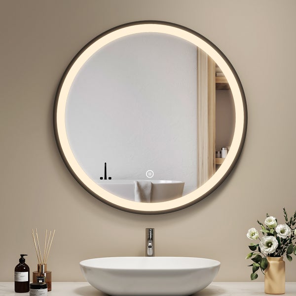Runder Badezimmerspiegel mit integrierter LED Beleuchtung und Touch Sensor über einem Waschbecken in modernem Badezimmer.
