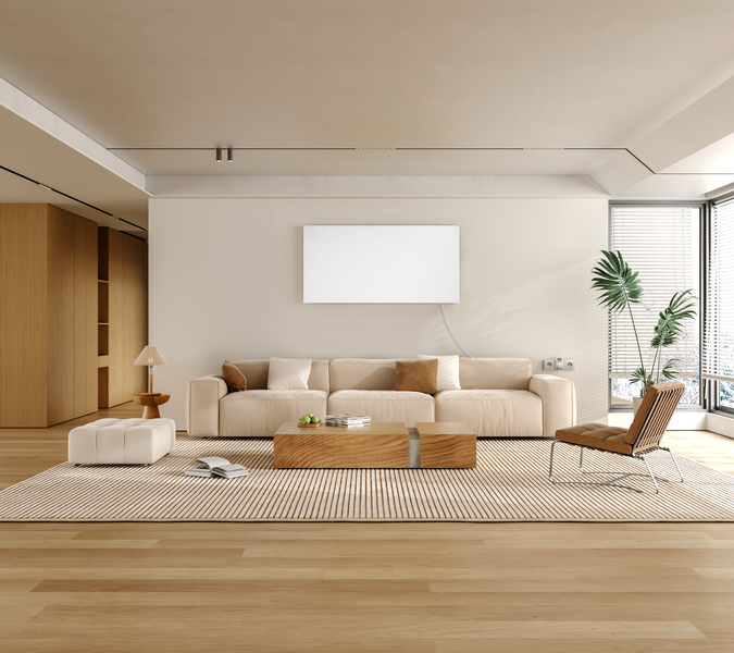 Ein helles, modernes Wohnzimmer mit einem Sofa, Holztisch, Infrarotheizung an der Wand und Parkettboden in minimalistischem Stil.