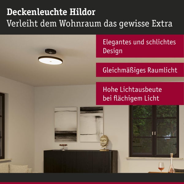 Moderne runde LED Deckenleuchte Hildor in Schwarz sorgt für gleichmäßiges Licht in einem hell eingerichteten Wohnzimmer über einer Anrichte.