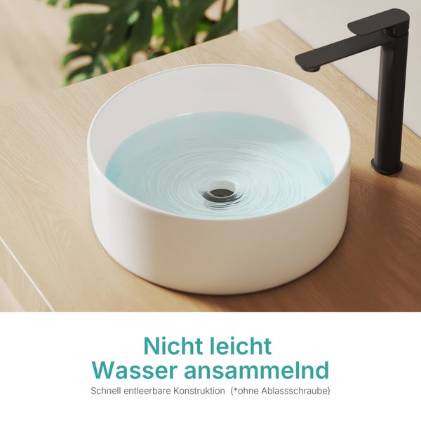 Rundes Aufsatzwaschbecken aus Keramik mit Wasserhahn auf einer Holzoberfläche