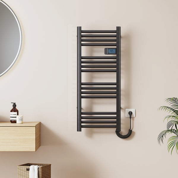 Elektrischer Handtuchheizkörper in moderner Optik, an der Wand montiert, mit digitalem Thermostat und Spiralkabel für den Anschluss an die Steckdose.
