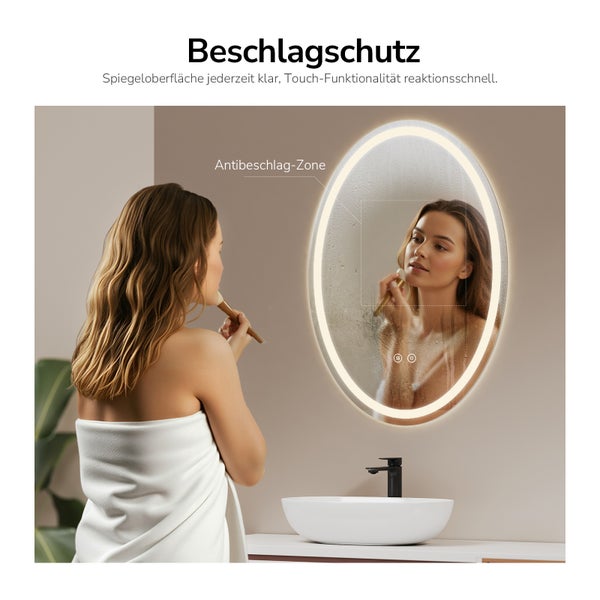 Ovaler Badezimmerspiegel mit LED Beleuchtung und Antibeschlag Funktion über einem Waschbecken in einer modern gestalteten Umgebung.