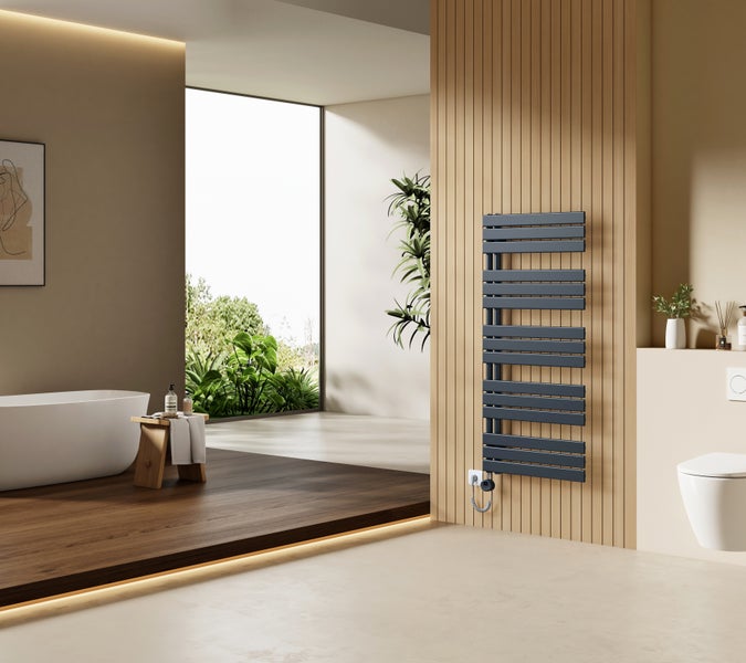 Moderner Badheizkörper an einer Holzlamellenwand in einem geräumigen Badezimmer mit freistehender Badewanne und Blick in den Garten.
