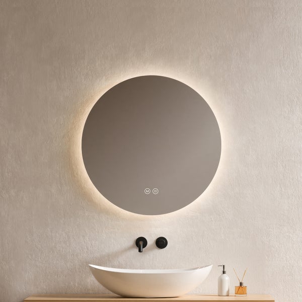 Moderner runder Badezimmerspiegel mit LED-Hintergrundbeleuchtung über einem weißen Aufsatzwaschbecken und schwarzer Armatur.