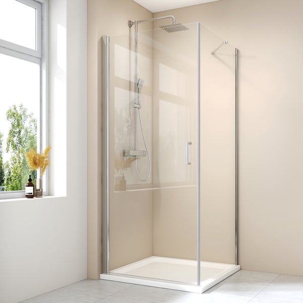 Moderne Eckdusche mit Glaselementen, verchromten Armaturen, Regenduschkopf und Duschwanne in einem hellen Badezimmer.