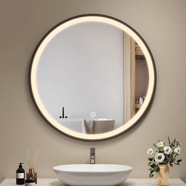 Runder Badezimmerspiegel mit LED Beleuchtung und Touch Schalter über einem Waschbecken in modernem Badezimmer.