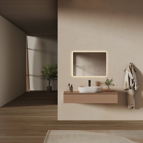 Modernes, minimalistisches Badezimmer mit hängendem Waschtisch aus Holz, weißem Aufsatzbecken und beleuchtetem LED-Spiegel an einer beigen Wand.