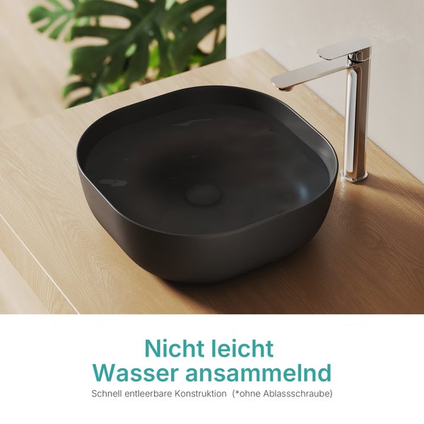 Aufsatzwaschbecken in Mattschwarz auf einer Holzkonsole mit verchromter Armatur, schnell entleerbare Konstruktion ohne Ablassschraube.