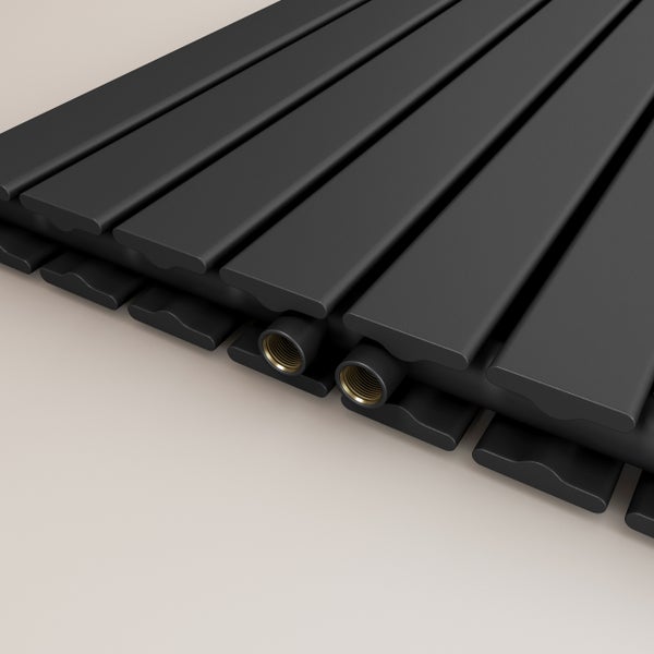 Nahaufnahme eines schwarzen Heizkörpers mit goldenen Anschlüssen