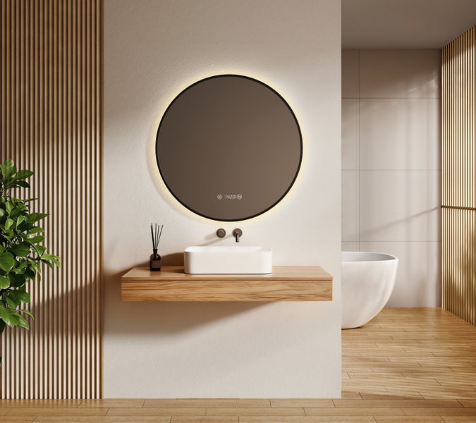 Modernes Badezimmer mit rundem LED-Spiegel, weißem Aufsatzwaschbecken auf einem Holzwaschtisch, schwarzer Armatur und freistehender Badewanne.