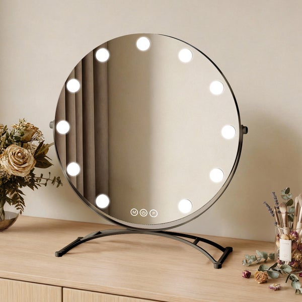 Runder Kosmetikspiegel mit Beleuchtung auf einer Kommode