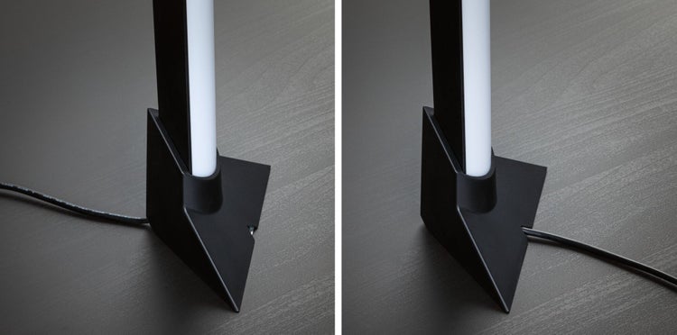 Zwei Tischleuchten mit dreieckigem Fuß auf einer Tischplatte