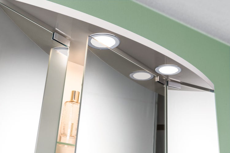 Detailaufnahme eines Spiegelschranks mit Beleuchtung und Glasablage