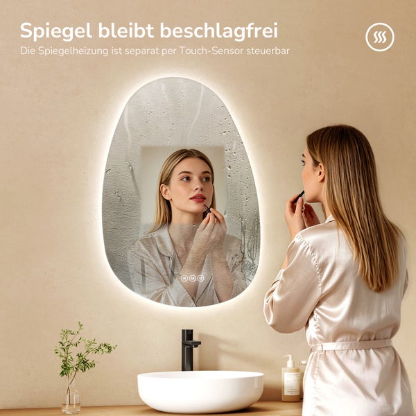 Ovaler LED-Badezimmerspiegel mit integrierter Spiegelheizung gegen Beschlag, steuerbar über Touch-Sensor, im Badezimmer mit Waschbecken.