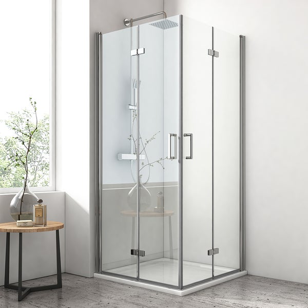 Eckduschkabine mit Klarglastüren und verchromten Metallprofilen, zwei Türgriffen und einem quadratischen Duschkopf in einem hellen Badezimmer.