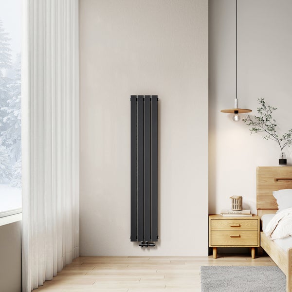 Vertikaler Heizkörper im Schlafzimmer mit Nachttisch und Fenster