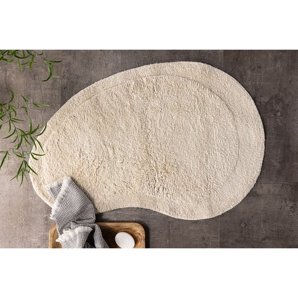 Detailansicht eines beigen Teppichs mit dezentem Muster