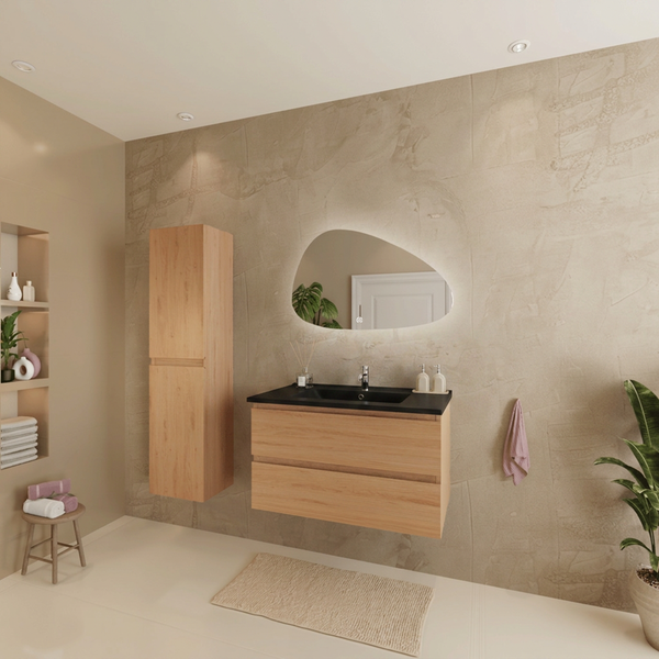 Modernes Badezimmer mit Waschtischunterschrank und Hochschrank in Holzoptik, organisch geformtem Lichtspiegel und dunklem Waschbecken.