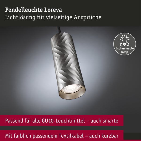 Moderne Küche mit kreisförmiger Hängeleuchte über einem runden Esstisch und hellen Küchenfronten mit Holzelementen.