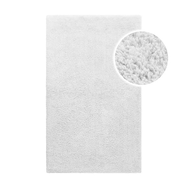 Weißer Badeteppich in rechteckiger Form mit Detailaufnahme der weichen Florstruktur.