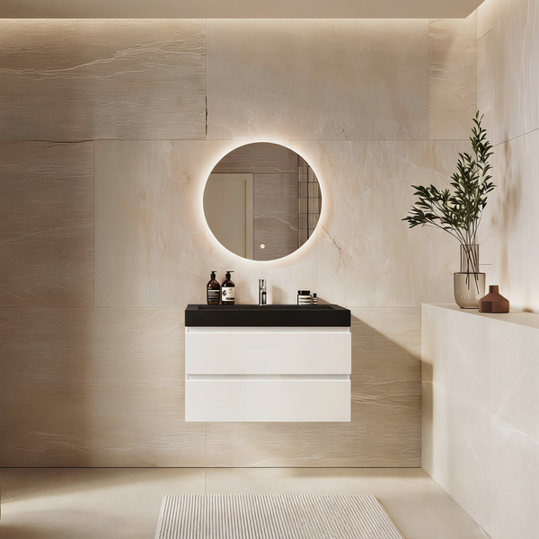 Modernes Badezimmer mit hängendem Waschtisch in Hochglanz, rundem beleuchtetem Spiegel und großformatigen Fliesen in Natursteinoptik.