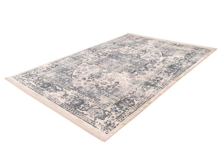 Rechteckiger Teppich im Vintage-Stil mit orientalischem Muster, Fransen an den Enden und verwaschenem Design in Blau und Beige.