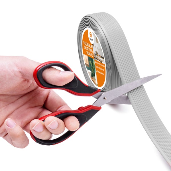 Flexible Sockelleiste auf Rolle wird mit einer Schere zugeschnitten.