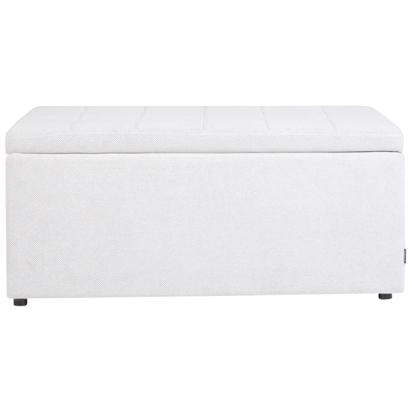 Gepolsterte Aufbewahrungsbox mit Knöpfen auf dem Deckel neben einem Holzschrank