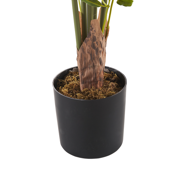 Detailansicht des Topfes mit künstlicher Pflanze und Dekormaterial.