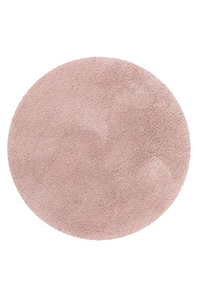 Runder Hochflor-Teppich mit weicher Oberfläche in der Farbe Rosa.