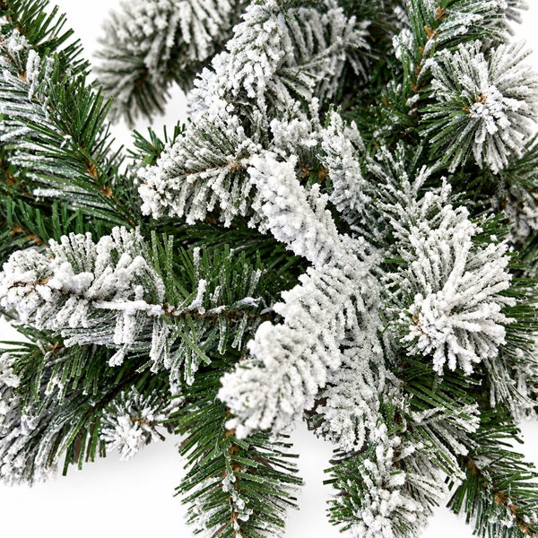 Künstlicher Tannenzweig mit Schneeoptik als Weihnachtsdekoration