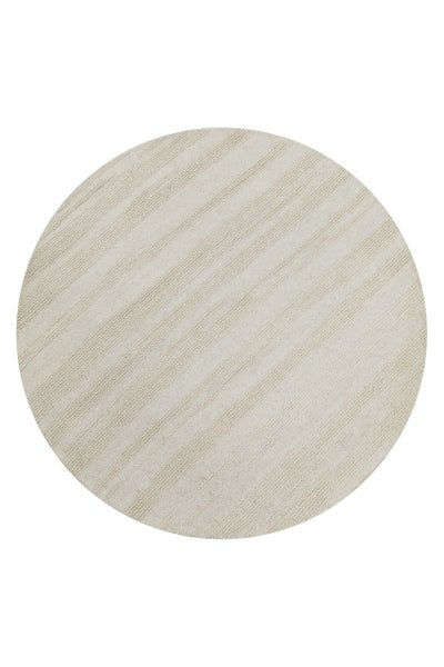 Runder Teppich mit diagonaler Rippenstruktur.