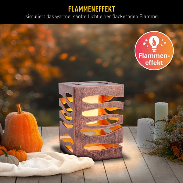 Dekorative Leuchte mit Flammeneffekt und Kürbissen als Herbstdekoration