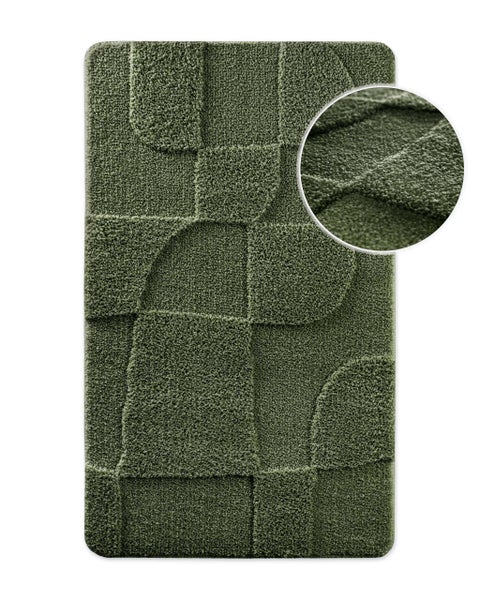 Rechteckige Badematte mit strukturiertem geometrischem Muster und Detailansicht der Faseroberfläche.