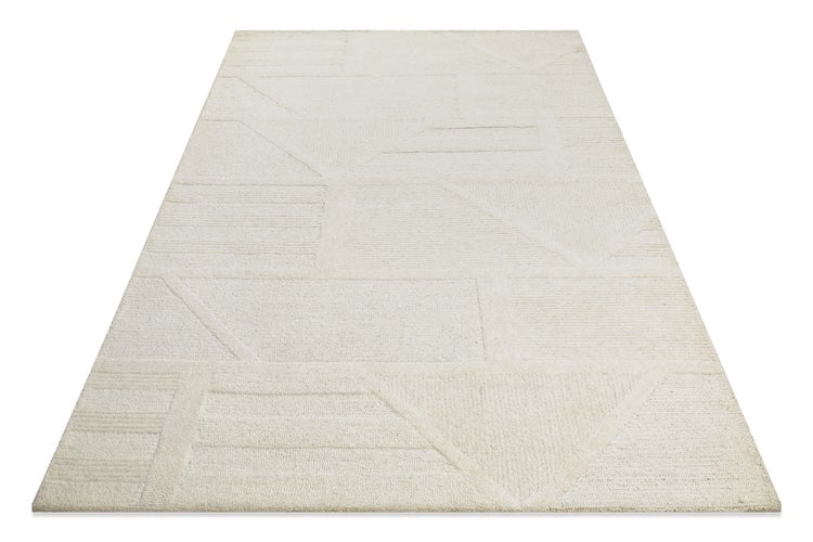 Nahaufnahme eines beigen Teppichs mit geometrischem 3D-Muster aus Linien und Kreisen mit verschiedenen Florhöhen.