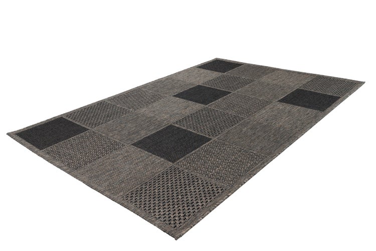 Rechteckiger Teppich mit Patchwork-Muster aus verschiedenen gewebten Quadraten in Grautönen.