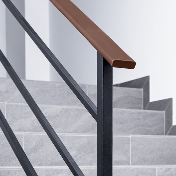 Detailaufnahme eines Treppengeländers mit Holzhandlauf und schwarzen Metallstreben