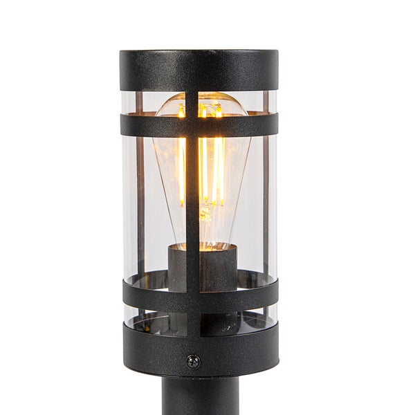 Zylindrische schwarze Außenleuchte mit Glaseinsatz und sichtbarem LED-Filament-Leuchtmittel.