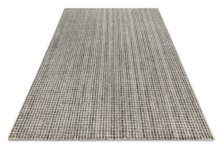 Rechteckiger Teppich mit einem Muster aus vertikalen Streifen bestehend aus kleinen Quadraten.