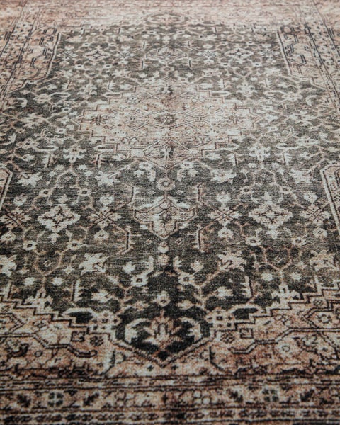 Kurzfloriger Teppich mit orientalischem Muster, zentralem Medaillon und Vintage-Effekt in Braun und Beige.