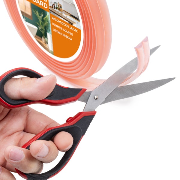 Eine flexible Sockelleiste wird mit einer Schere zugeschnitten.