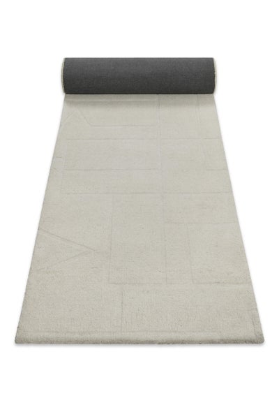 Teppichläufer mit geometrischem Muster aus Rechtecken und Linien, hellbeige mit dunkler Rückseite.