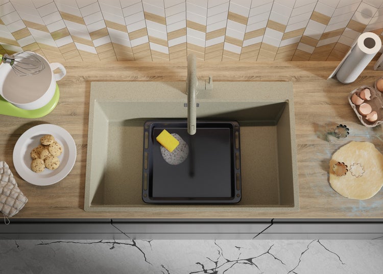 Küchenspüle mit Backblech, Schwamm und Spülmittel auf einer Küchenarbeitsplatte