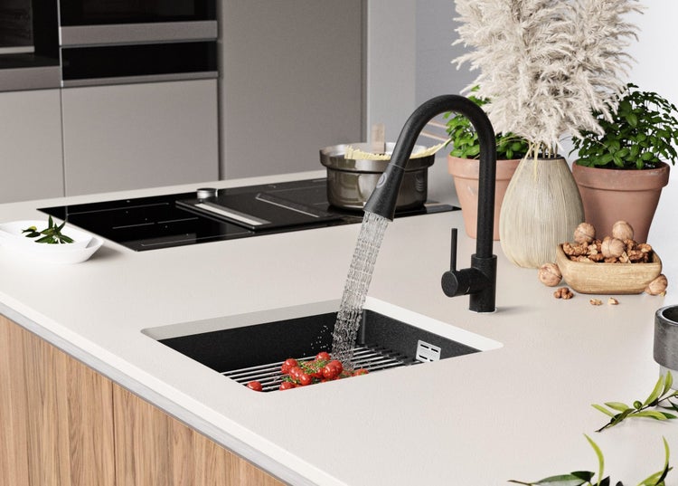 Küchenspüle mit Armatur, Gemüse und Dekoration auf der Arbeitsfläche